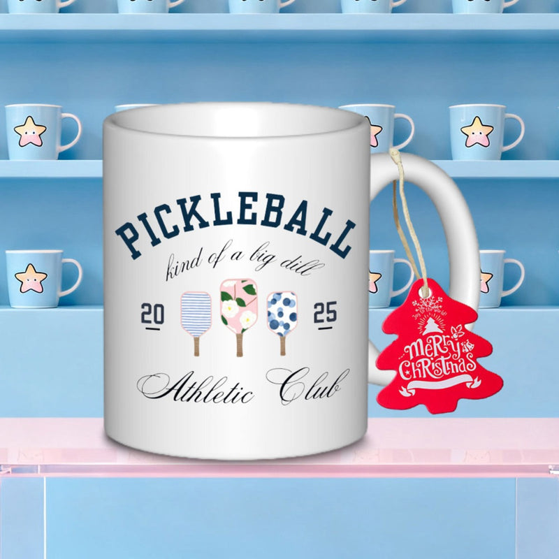 Tailorly White Ceramic 11 oz Mug - Pickleball Kind Of A Big Dill Athletic Club Three Patterned Sports Paddles Featuring Floral And Dotted Designs Among Text Paddle