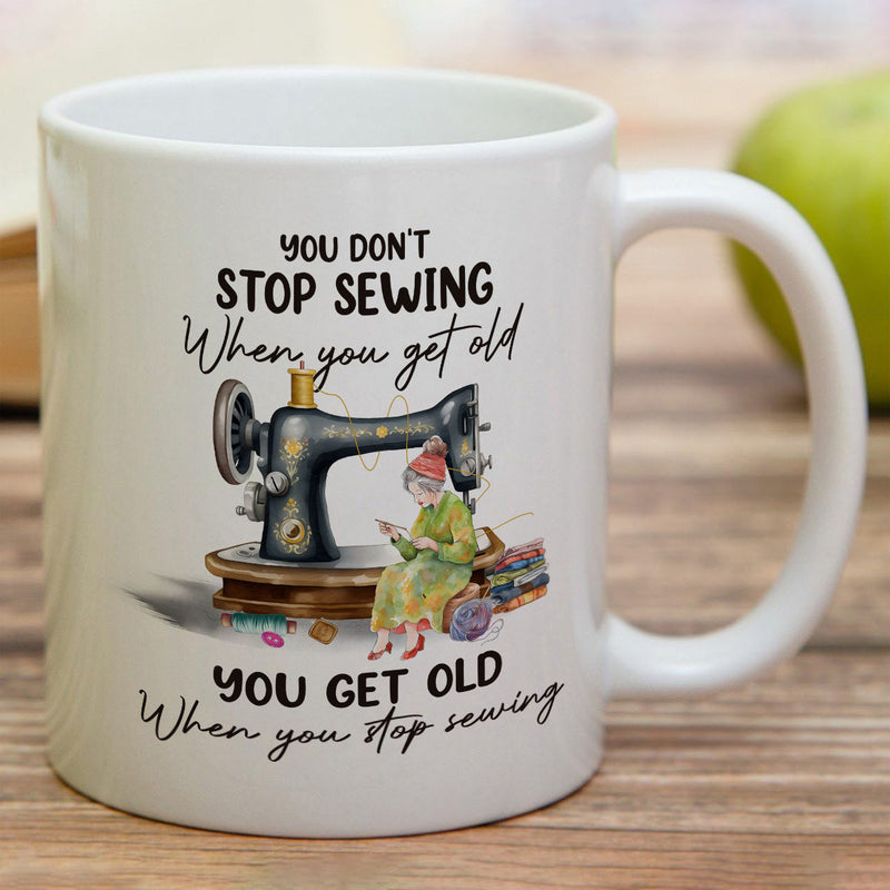 Tailorly White Ceramic 11 oz Mug - You Don't Stop Sewing When You Get Old You Get Old When You Stop Sewing Vintage Black Machine On A Wooden Base With Colorful