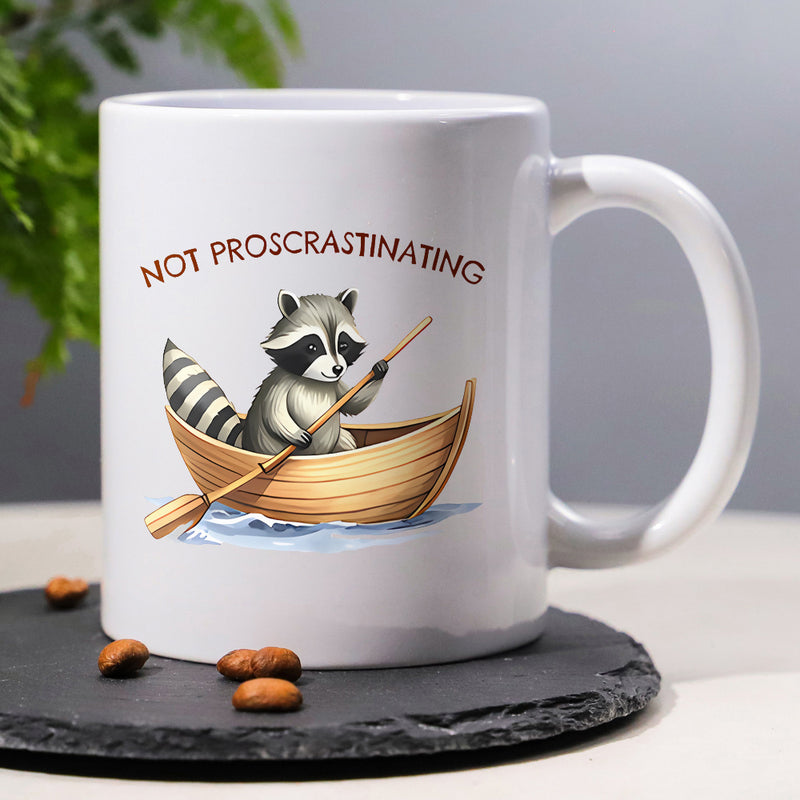 Tailorly White Ceramic 11 oz Mug - Not Procrastinating Cute Adventurous Animal Paddling A Small Wooden Rowboat Over Gentle Ripples Raccoon