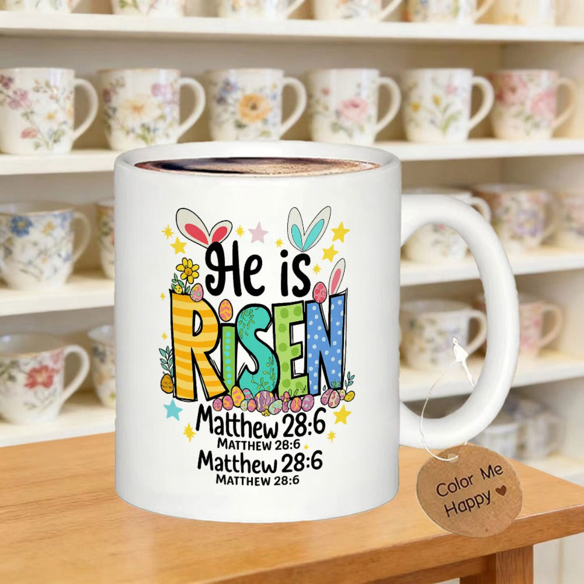 Tailorly White Ceramic 11 oz Mug - He Is Risen Matthew 28 6 Colorful Patterned Letters With Cute Bunny Ears Among Festive Easter Eggs Mug