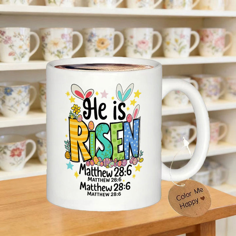 Tailorly White Ceramic 11 oz Mug - He Is Risen Matthew 28 6 Colorful Patterned Letters With Cute Bunny Ears Among Festive Easter Eggs Mug
