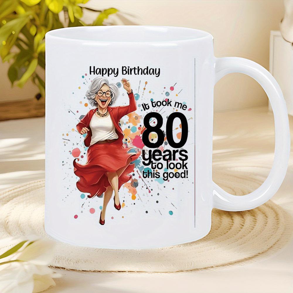 Tailorly White Ceramic 11 oz Mug - Happy Birthday It Took Me 80 Years To Look This Good Joyful Dancing Grandma Amidst Colorful Vibrant Confetti Splatters Wearing A