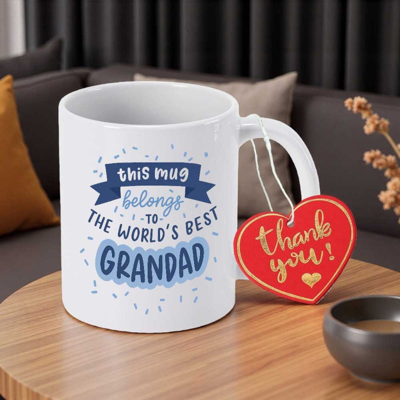 Tailorly White Ceramic 11 oz Mug - This Mug Belongs To The World's Best Grandad Blue Banner Decoration Among Floating Confetti On Ceramic Mug