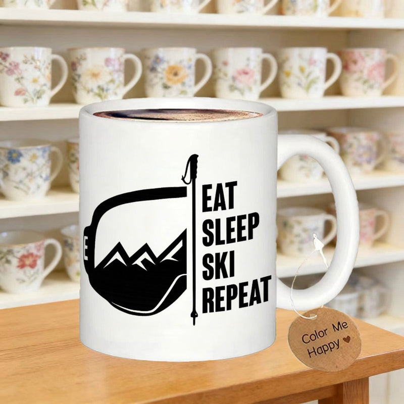 Tailorly White Ceramic 11 oz Mug - Eat Sleep Ski Repeat Snowy Mountain Peaks Inside Ski Goggles Frame Next To Vertical Ski Pole Goggles