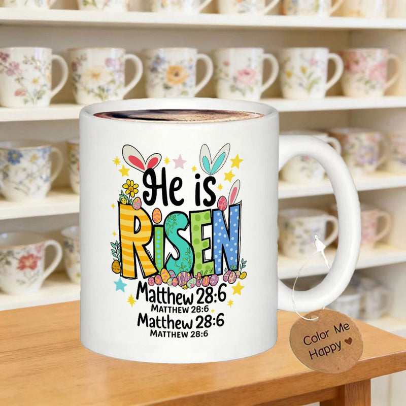Tailorly White Ceramic 11 oz Mug - He Is Risen Matthew 28 6 Colorful Patterned Letters With Bunny Ears Among Stars And Easter Eggs Mug