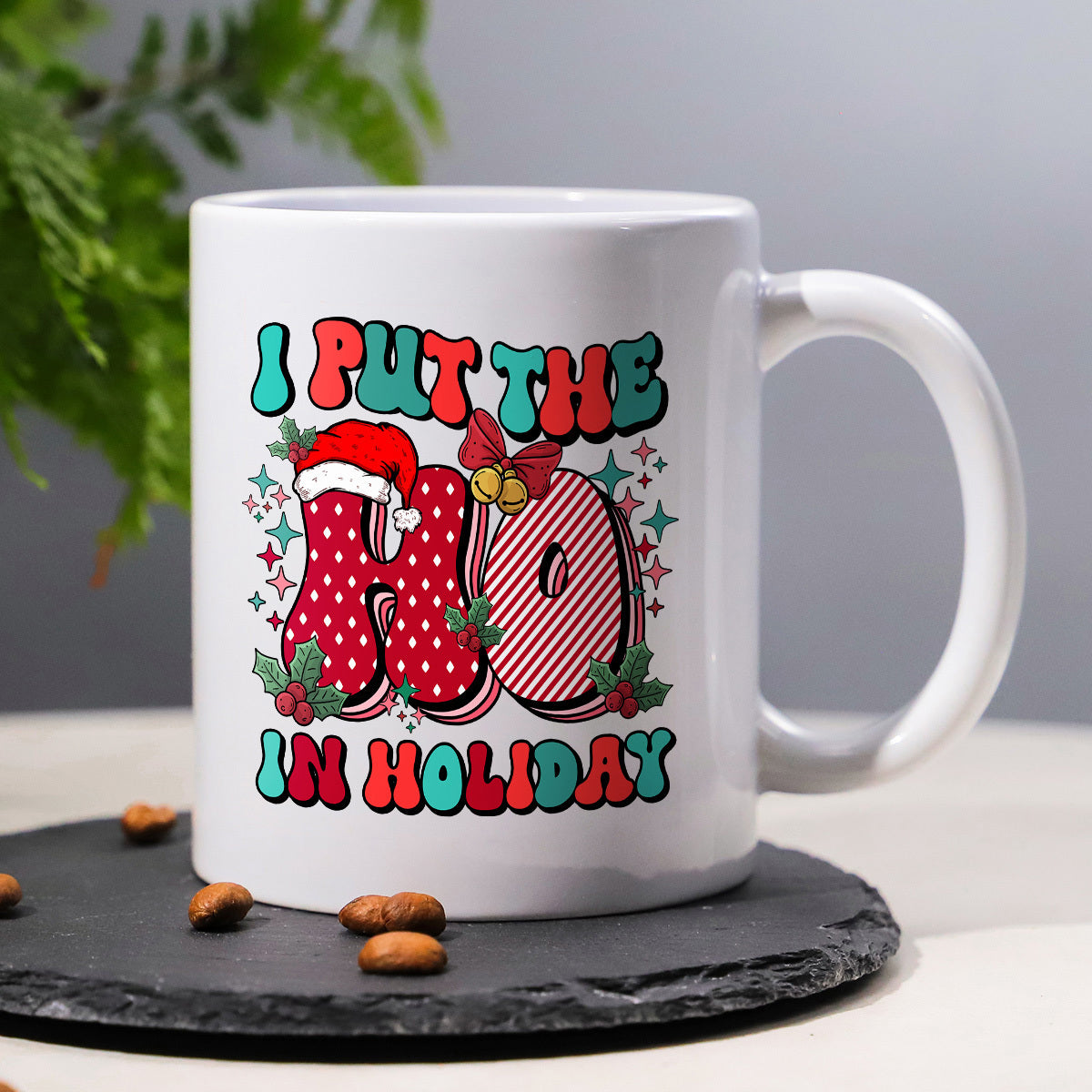 Tailorly White Ceramic 11 oz Mug - I Put The Ho In Holiday Festive Christmas Elements With Santa Hat And Stars Surrounding Bold Retro Letters Mug