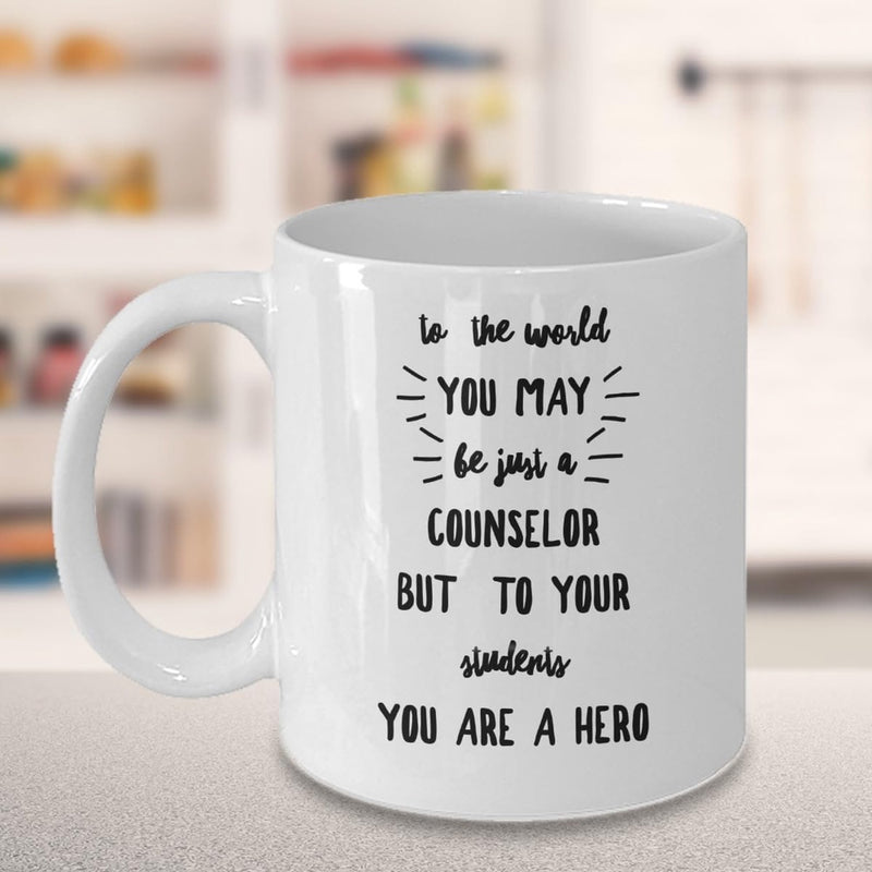 Tailorly White Ceramic 11 oz Mug - To The World You May Be Just A Counselor But To Your Students You Are A Hero Polished With Radiant Burst Lines And Lettering Mug