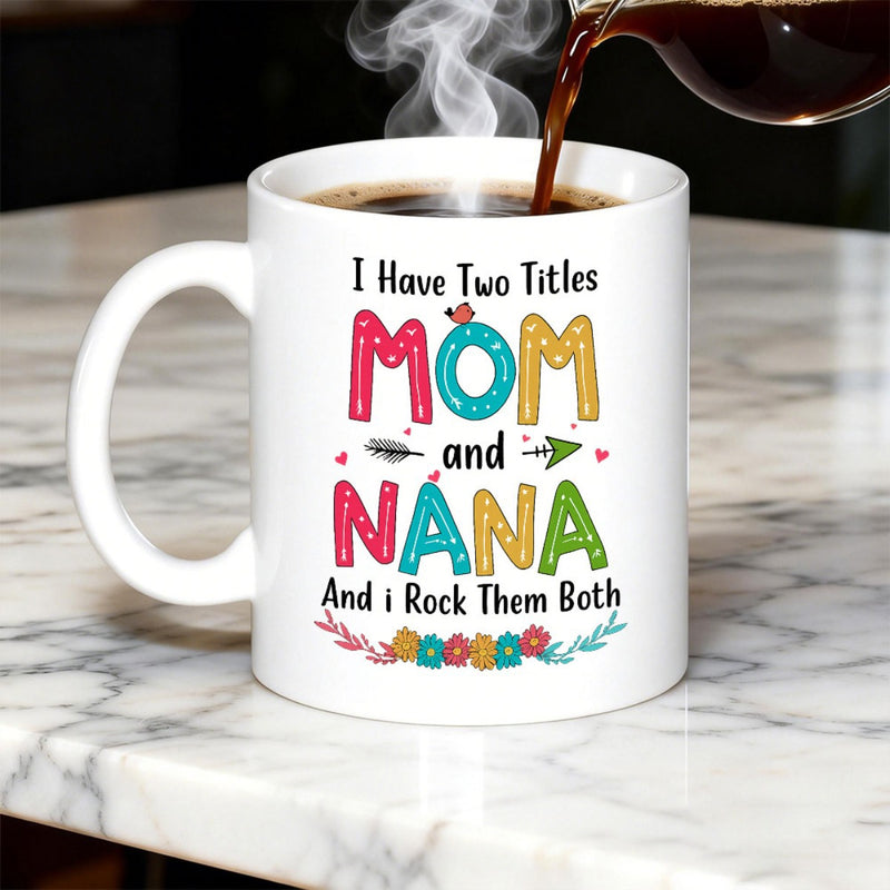 Tailorly White Ceramic 11 oz Mug - I Have Two Titles Mom And Nana And I Rock Them Both Colorful Patterned Letters Surrounded By Small Floral Wreath And Arrows Mug