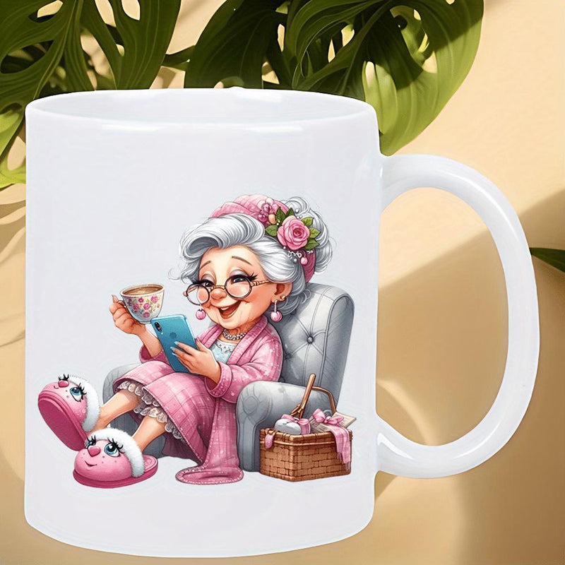 Tailorly White Ceramic 11 oz Mug - Cartoon Style Elderly Woman Relaxing In Pink Robe Holding Tea And Phone Grandmother