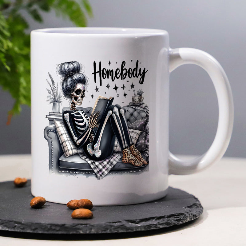 Tailorly White Ceramic 11 oz Mug - Homebody Relaxing On A Soft Cushion While Reading A Tiny Book Skeleton