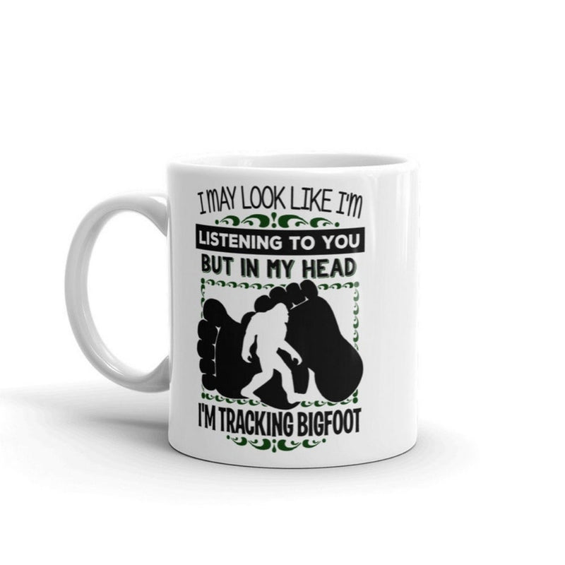 Tailorly White Ceramic 11 oz Mug - I May Look Like I'm Listening To You But In My Head I'm Tracking Bigfoot Walking Silhouette Set Between Two Large Dark Textured