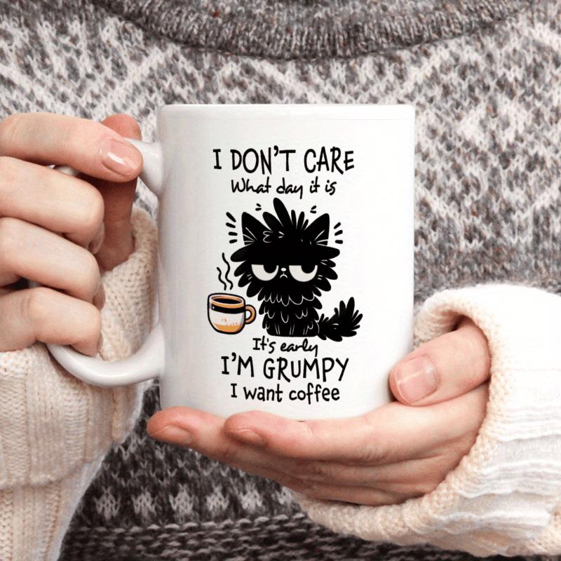Tailorly White Ceramic 11 oz Mug - I Don't Care What Day It Is It's Early I'm Grumpy I Want Coffee Messy Black Furry Cat Holding A Warm Cup Of Morning Coffee Cat