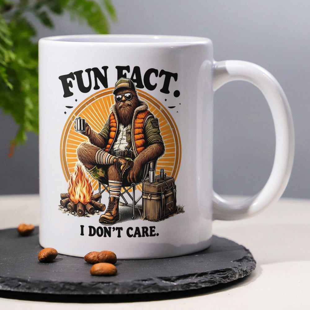 Tailorly White Ceramic 11 oz Mug - Fun Fact I Don't Care Relaxed Creature Wearing Sunglasses Sitting By Campfire Under Sunburst Sasquatch