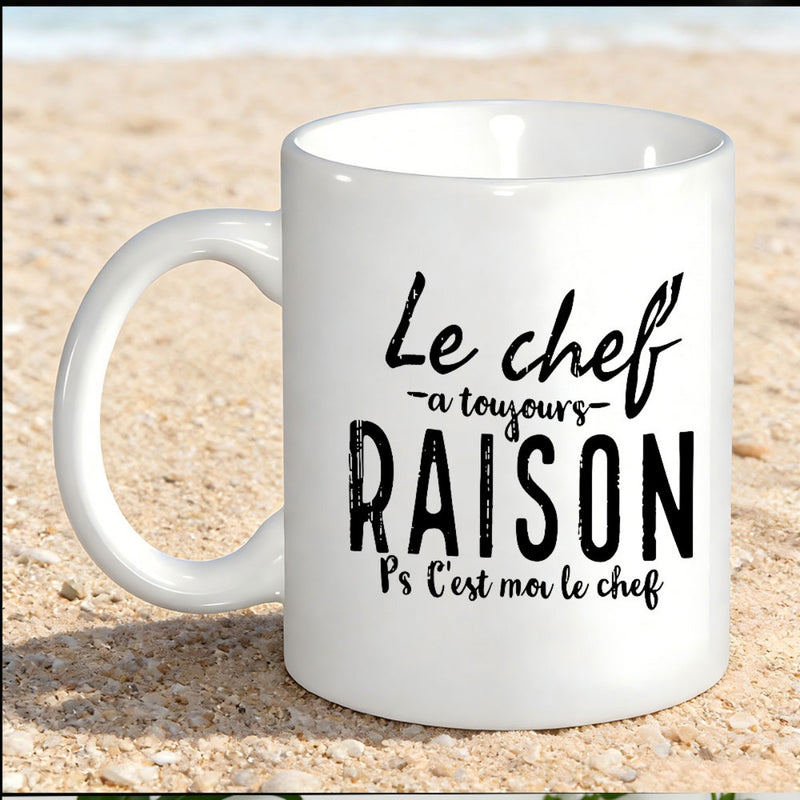 Tailorly White Ceramic 11 oz Mug - Minimalist White Ceramic Kitchenware Featuring Bold Typography Sitting On Beach Sand Mug