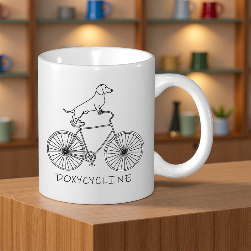 Tailorly White Ceramic 11 oz Mug - Doxycycline Whimsical Line Art Style Dachshund Riding On A Vintage Classic Bicycle
