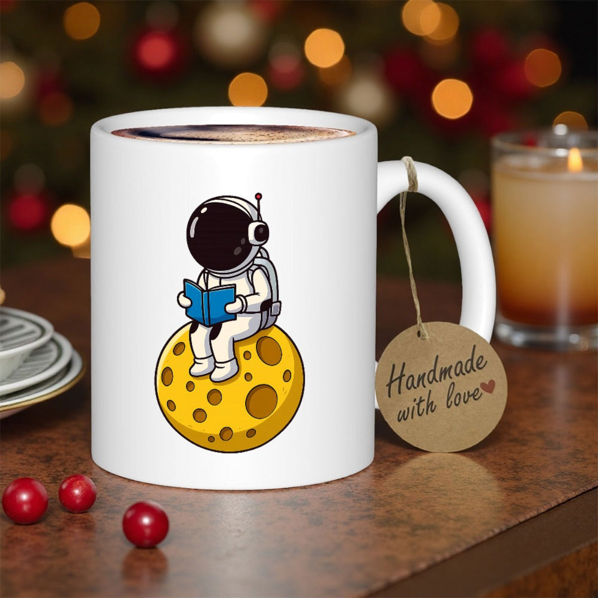 Tailorly White Ceramic 11 oz Mug - Reading A Blue Book Sitting On A Yellow Cratered Moon Astronaut