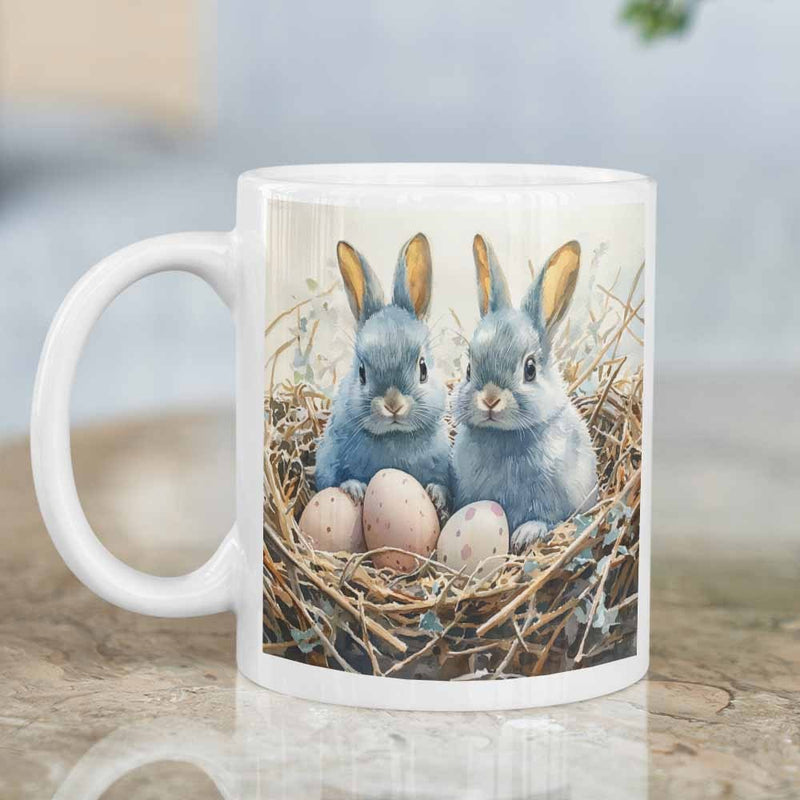 Tailorly White Ceramic 11 oz Mug - Two Small Grey Rabbits Nestled Together Within A Straw Bed With Eggs Rabbit