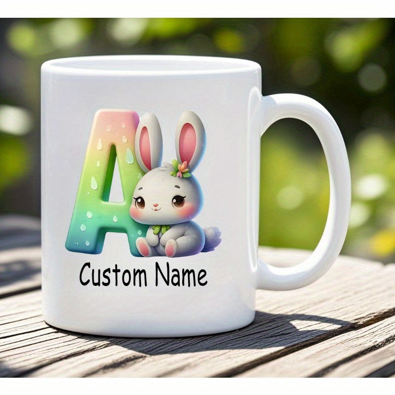 Tailorly White Ceramic 11 oz Mug - Custom Name Adorable Cartoon Bunny Sitting Beside Large Colorful Gradient Letter Rabbit