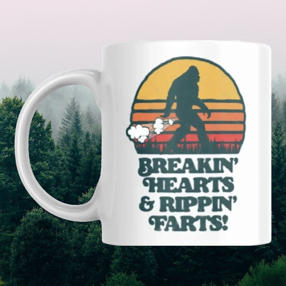 Tailorly White Ceramic 11 oz Mug - Breakin Hearts Rippin Farts Retro Sunset Background With Mythical Sasquatch Walking Through Forest Trees Bigfoot