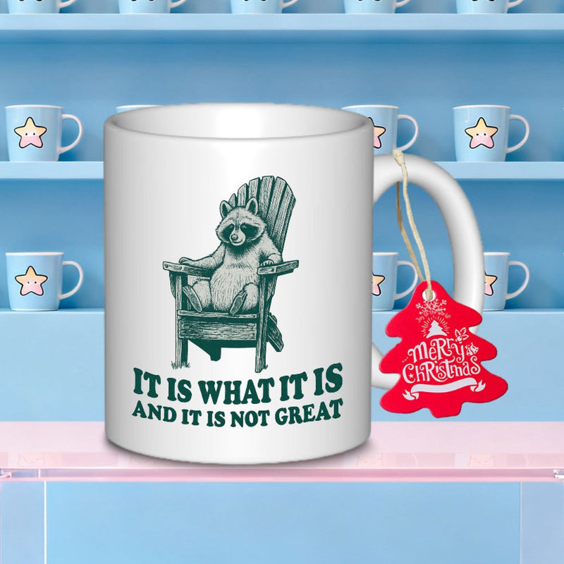 Tailorly White Ceramic 11 oz Mug - It Is What It Is And It Is Not Great Chubby Raccoon Sitting Comfortably In A Wooden Adirondack Style Chair Raccoon