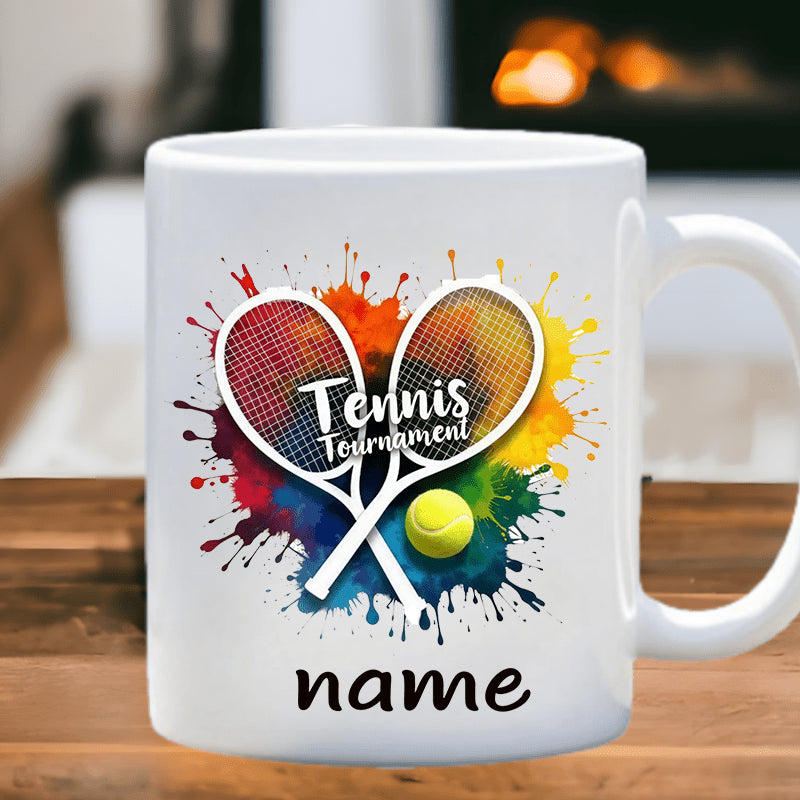 Tailorly White Ceramic 11 oz Mug - Tennis Tournament Name Colorful Artistic Paint Splashes With Crossed Sports Equipment And A Tennis Ball Racket
