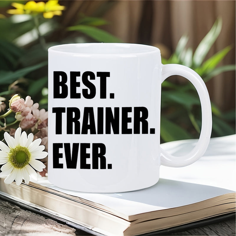 Tailorly White Ceramic 11 oz Mug - Best Trainer Ever Minimalist Ceramic Vessel Sitting On A Rustic Book In Natural Light Mug