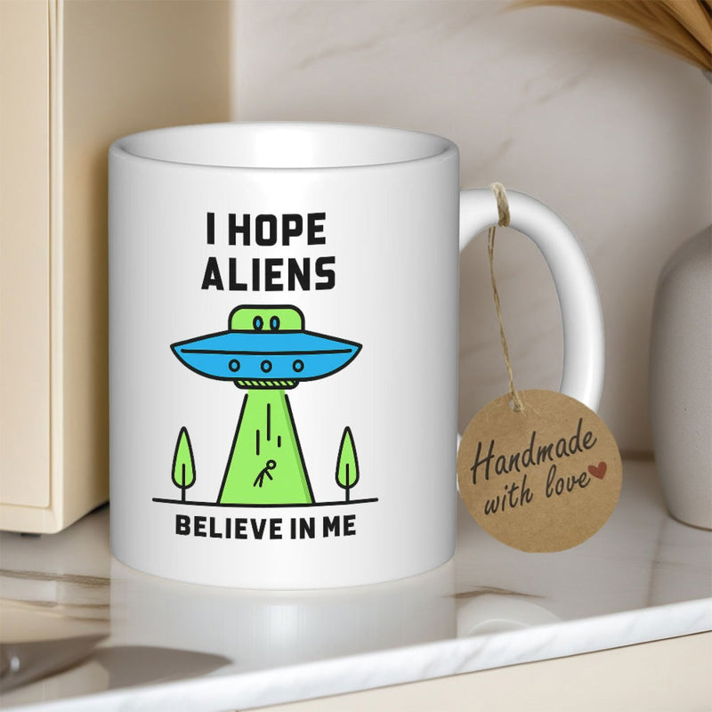 Tailorly White Ceramic 11 oz Mug - I Hope Aliens Believe In Me Cartoon Spaceship Hovering Over Trees With Abduction Light Beam And Stick Figure Spaceship