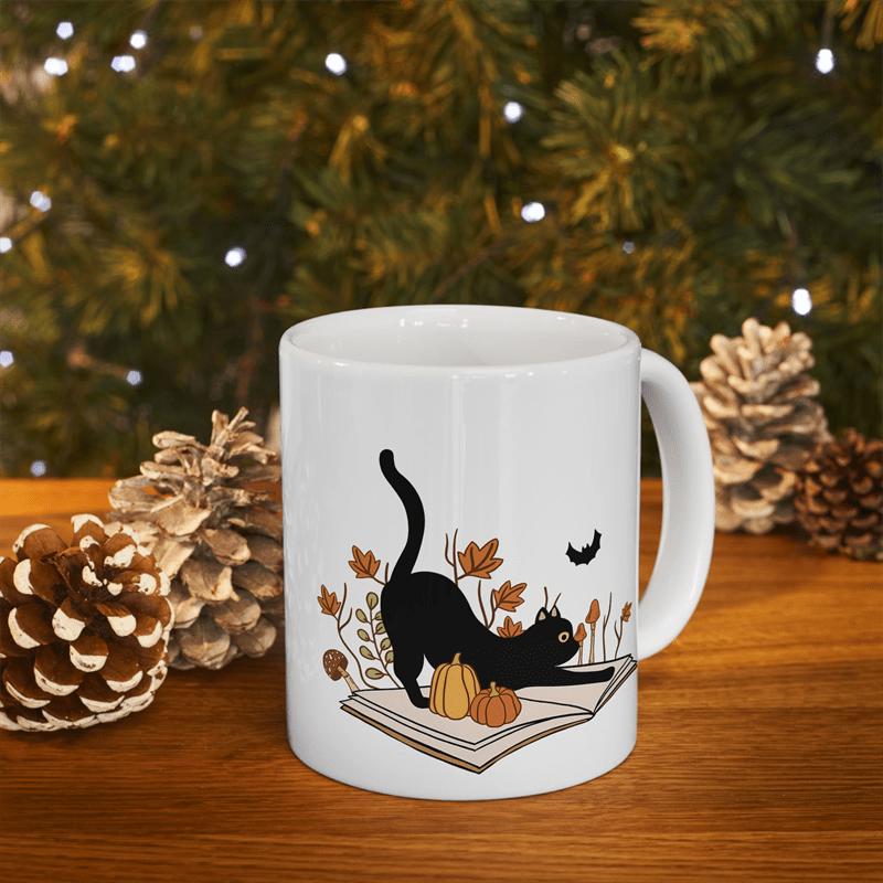 Tailorly White Ceramic 11 oz Mug - Playful Black Cat Stretching Over Open Book Among Autumn Leaves And Pumpkins Cat