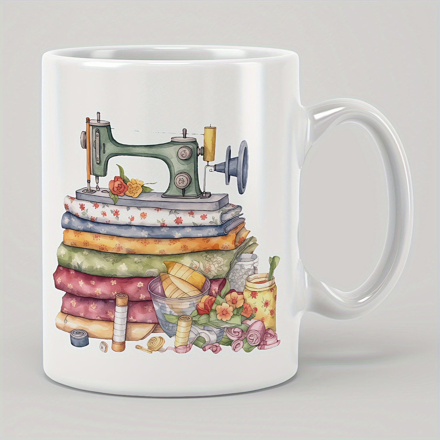 Tailorly White Ceramic 11 oz Mug - Vintage Green Device Resting On Stacked Colorful Patterned Fabrics And Flowers Sewing Machine