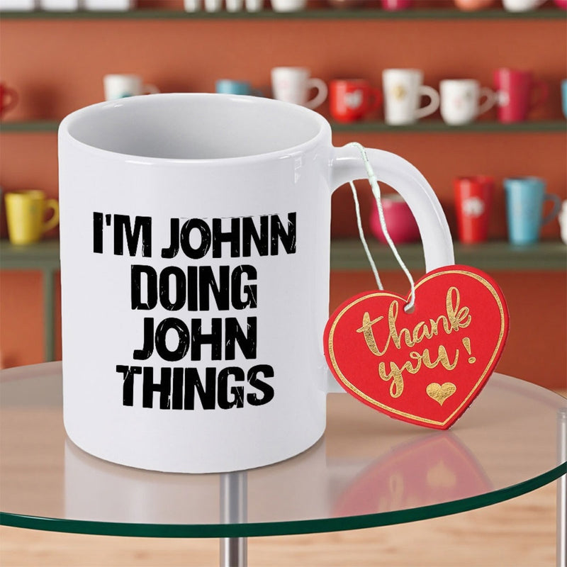 Tailorly White Ceramic 11 oz Mug - Im Johnn Doing John Things Minimalist Ceramic Vessel Featuring Bold Black Sans Serif Typography Displayed On Surface Mug