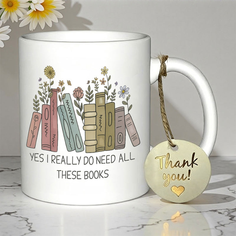 Tailorly White Ceramic 11 oz Mug - Yes I Really Do Need All These Books Row Of Pastel Books With Delicate Wildflowers Blooming Among The Spines Books