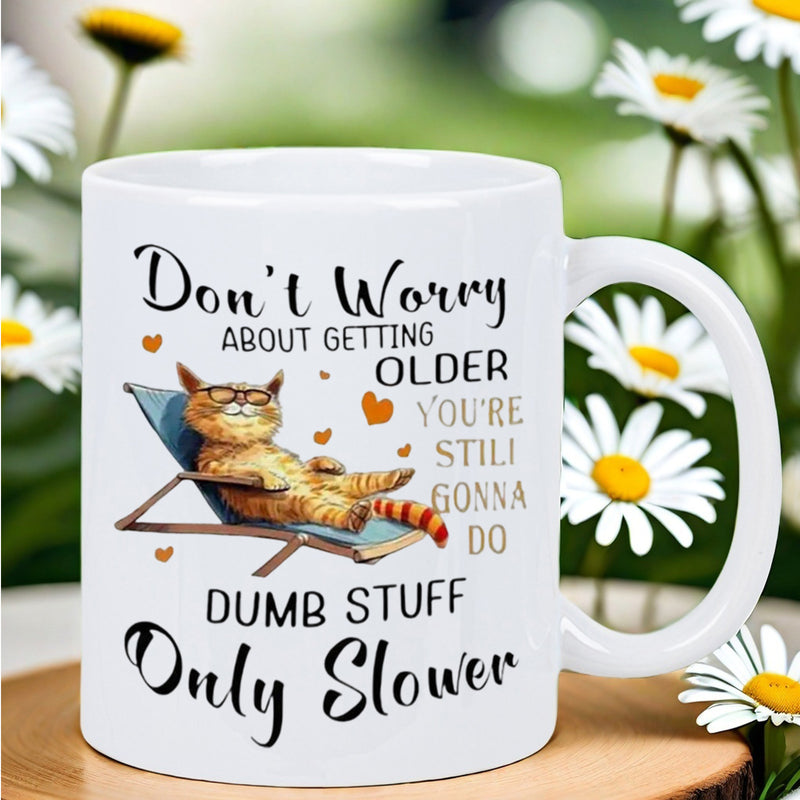 Tailorly White Ceramic 11 oz Mug - Don't Worry About Getting Older You're Still Gonna Do Dumb Stuff Only Slower Orange Tabby Cat Relaxing On A Blue Lounge Chair