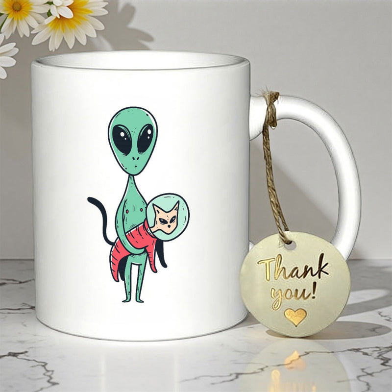 Tailorly White Ceramic 11 oz Mug - Minimalist Green Extraterrestrial Being Holding A Small Feline Wearing Astronaut Suit Alien