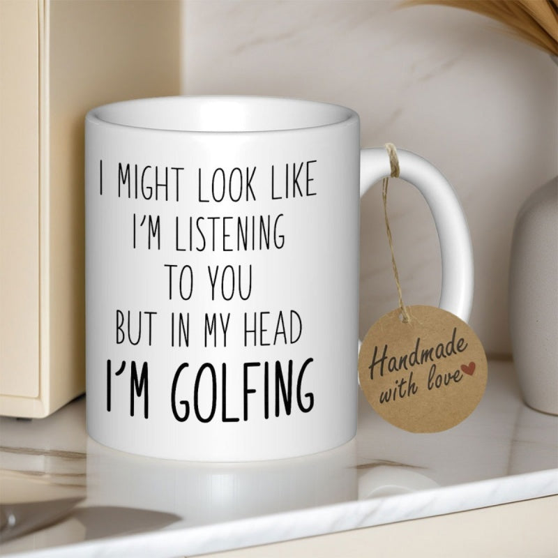 Tailorly White Ceramic 11 oz Mug - I Might Look Like Im Listening To You But In My Head Im Golfing Minimalist Black Hand Drawn Style Typography On White Surface