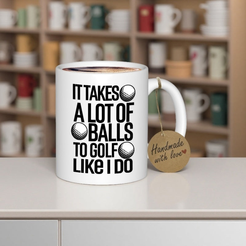 Tailorly White Ceramic 11 oz Mug - It Takes A Lot Of Balls To Golf Like I Do Bold Sans Serif Typography Featuring Three Detailed Textured Round Sports Balls Mug