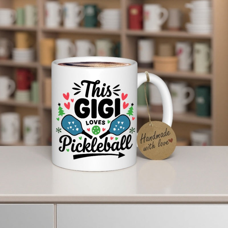 Tailorly White Ceramic 11 oz Mug - This Gigi Loves Pickleball Vibrant Blue Paddles Surrounded By Small Hearts And Pine Trees Mug