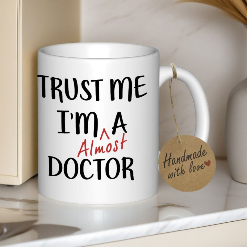 Tailorly White Ceramic 11 oz Mug - Trust Me Im A Almost Doctor Minimalist White Ceramic Vessel Displaying Humorous Medical Student Profession Quote Mug