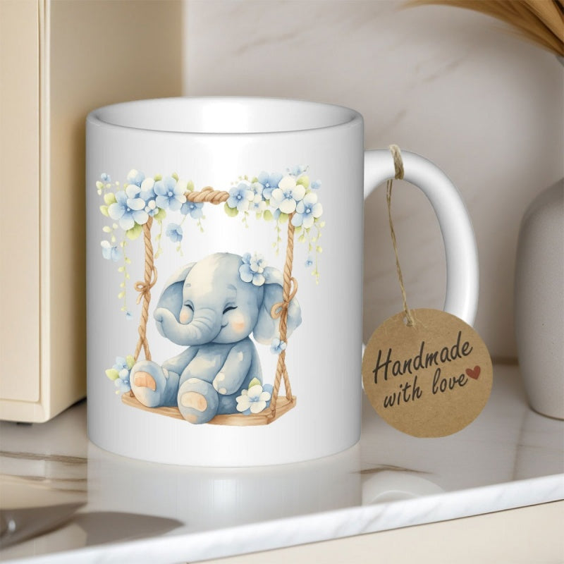 Tailorly White Ceramic 11 oz Mug - Handmade With Love Soft Blue Watercolor Style Sitting Peacefully On Floral Decorated Wooden Swing Elephant