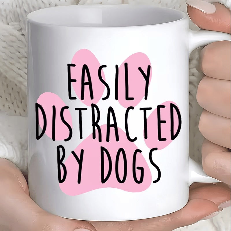 Tailorly White Ceramic 11 oz Mug - Easily Distracted By Dogs Minimalistic Pink Paw Print Silhouette Behind Bold Black Playful Script Paw