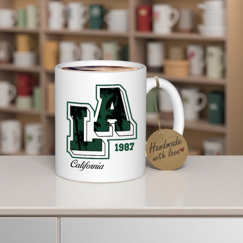 Tailorly White Ceramic 11 oz Mug - LA 1987 California Handmade With Love Bold Block Varsity Letters With Dark Green Tropical Palm Tree Pattern Sign