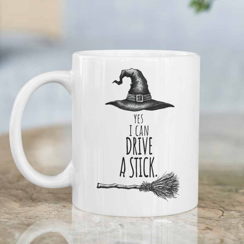 Tailorly White Ceramic 11 oz Mug - Yes I Can Drive A Stick Pointed Wizard Hat Above A Rustic Flying Wooden Broomstick
