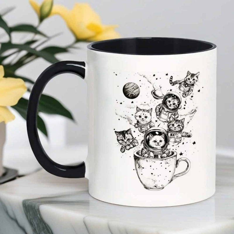 Tailorly Black Accent 11 oz Mug - black and white cats in astronaut outfits against outer space backdrop