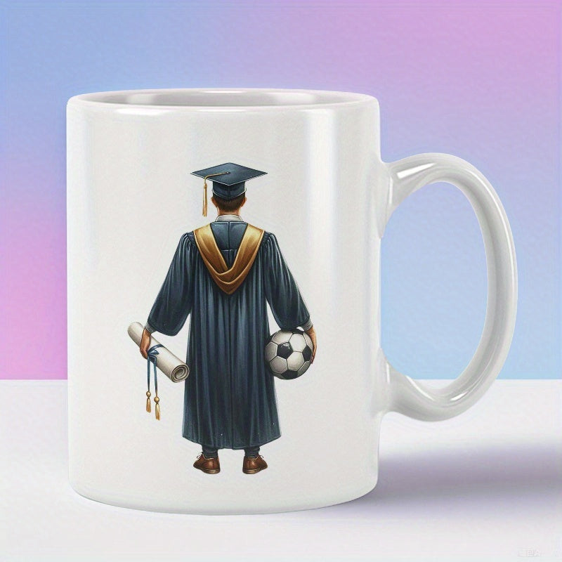 Tailorly White Ceramic 11 oz Mug - Male Student Wearing Traditional Academic Gown Holding Diploma And Soccer Ball Graduate