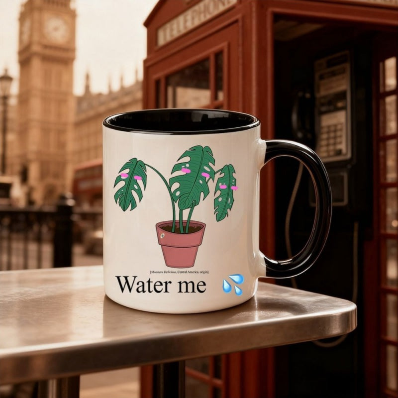 Tailorly Black Accent 11 oz Mug - cartoon monstera potted plant illustration with "water me" text in blue