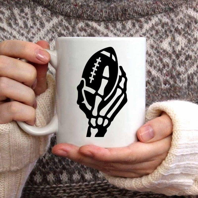 Tailorly White Ceramic 11 oz Mug - Skeleton Hand Holding A Classic American Professional Sport Style Football