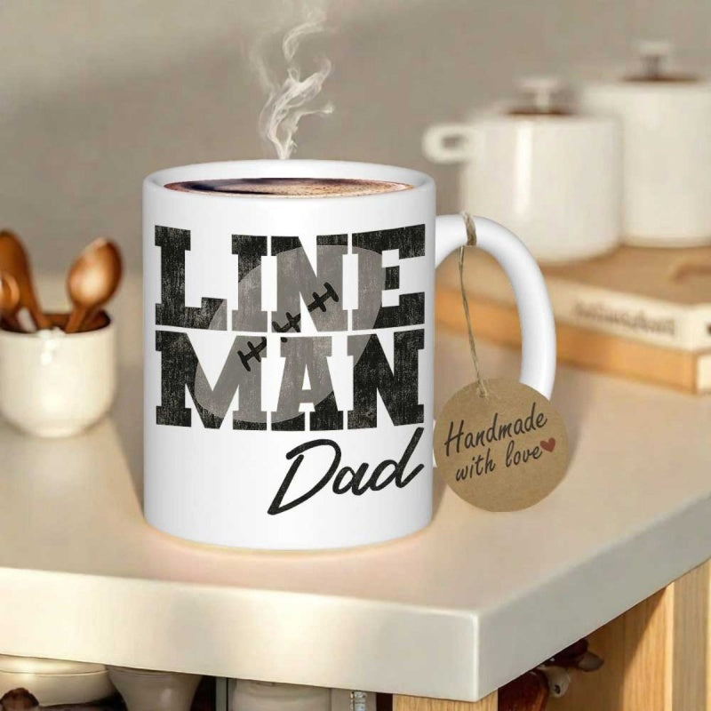Tailorly White Ceramic 11 oz Mug - Lineman Dad Bold Distressed Block Lettering Featuring Small Football Stitching Motifs On Ceramic Mug