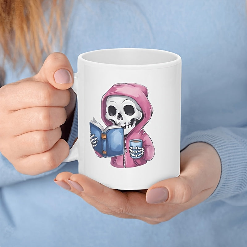 Tailorly White Ceramic 11 oz Mug - Cute Tiny Character Wearing Pink Hoodie Reading A Small Blue Book Skeleton