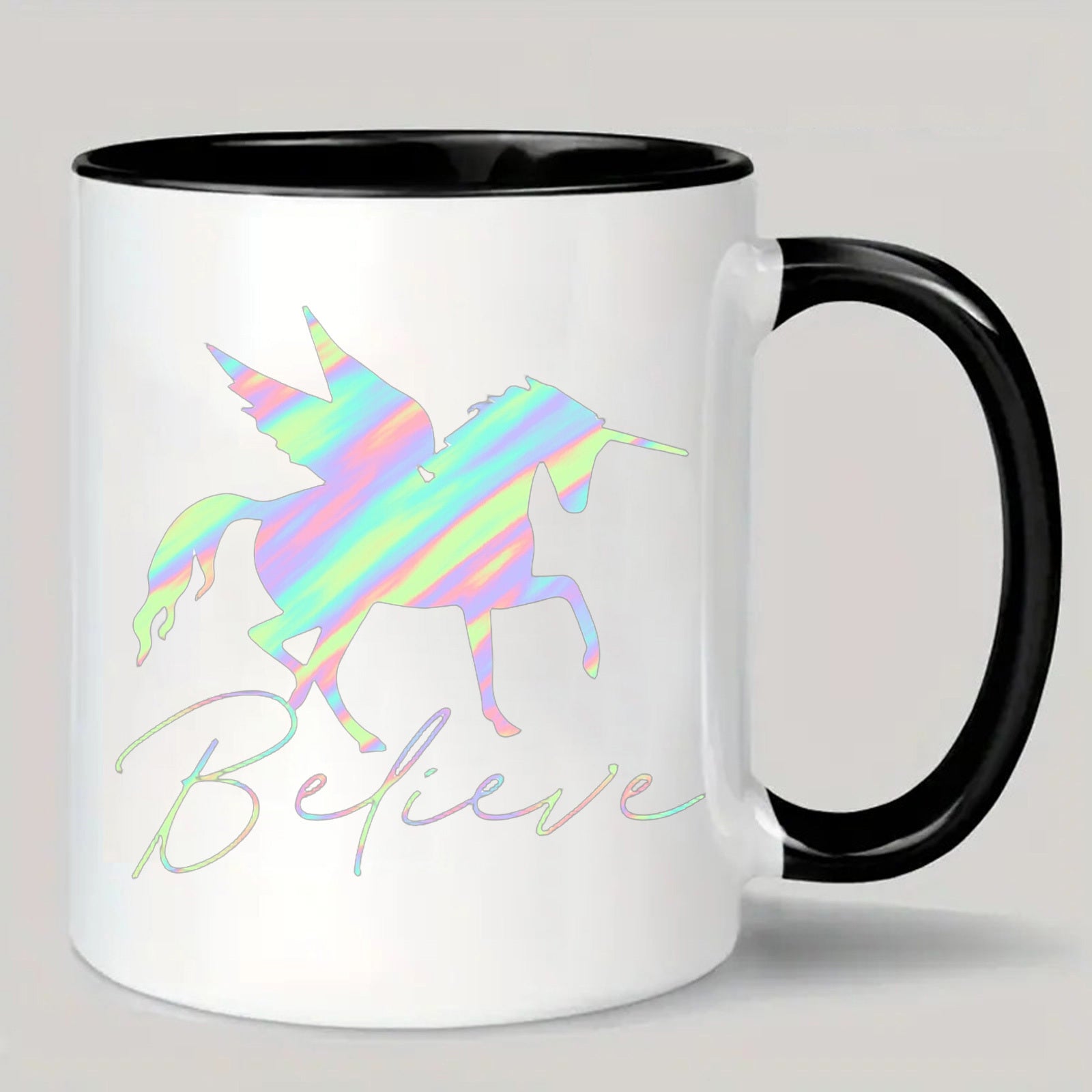 Tailorly Black Accent 11 oz Mug - unicorn with rainbow mane and iridescent scales and the word "believe"