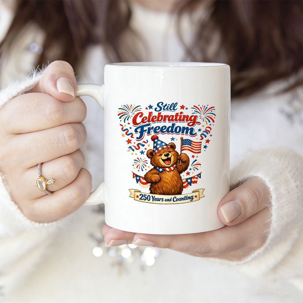 Tailorly White Ceramic 11 oz Mug - Still Celebrating Freedom 250 Years And Counting Festive Patriotic Cartoon Bear Holding A Flag Among Fireworks Bear