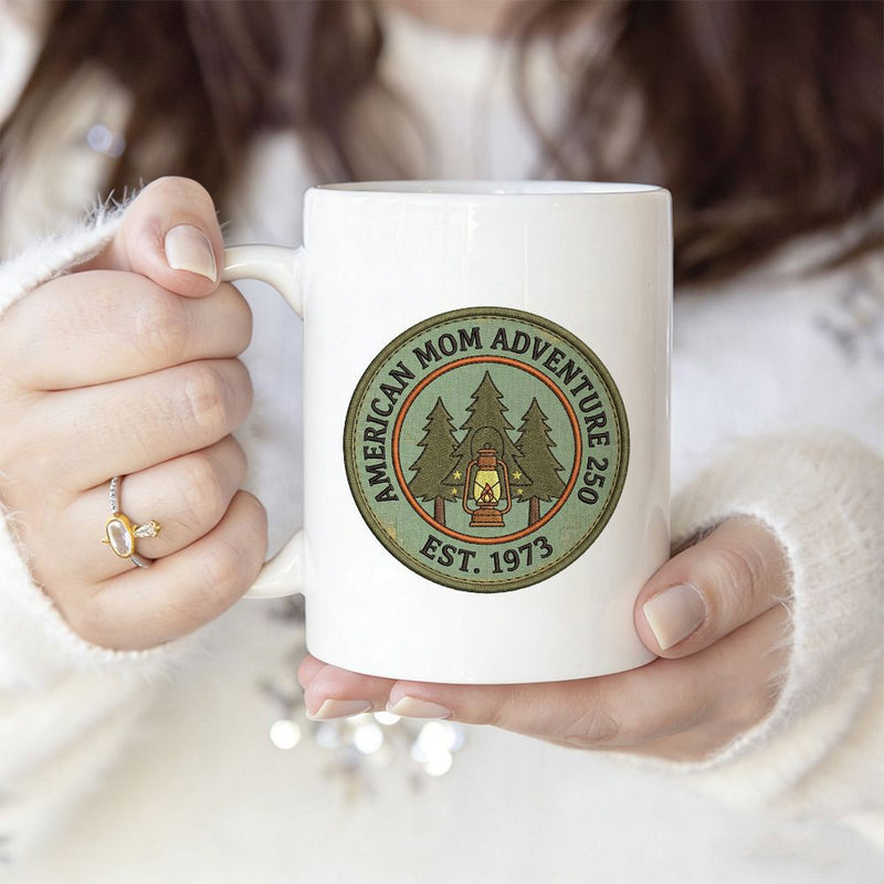 Tailorly White Ceramic 11 oz Mug - American Mom Adventure 250 Est 1973 Rustic Circular Frame With Evergreen Pine Trees And Glowing Lantern Badge